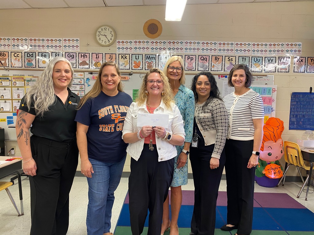 Mrs. Mullings with admin and grant presenters getting her mini- grant.