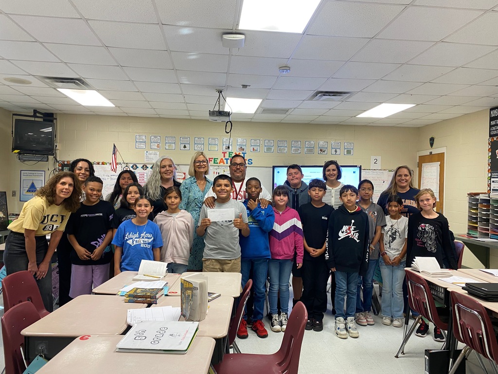 Mr. Ramirez with students, admin and grant presenters getting his mini- grant.
