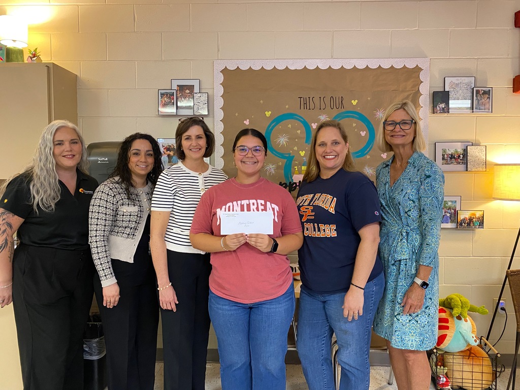 Miss Jackson with admin and grant presenters getting her mini- grant.