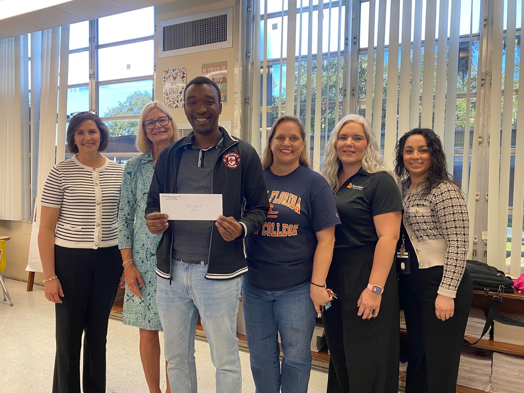 Mr. Lawson with admin and grant presenters getting his mini- grant.