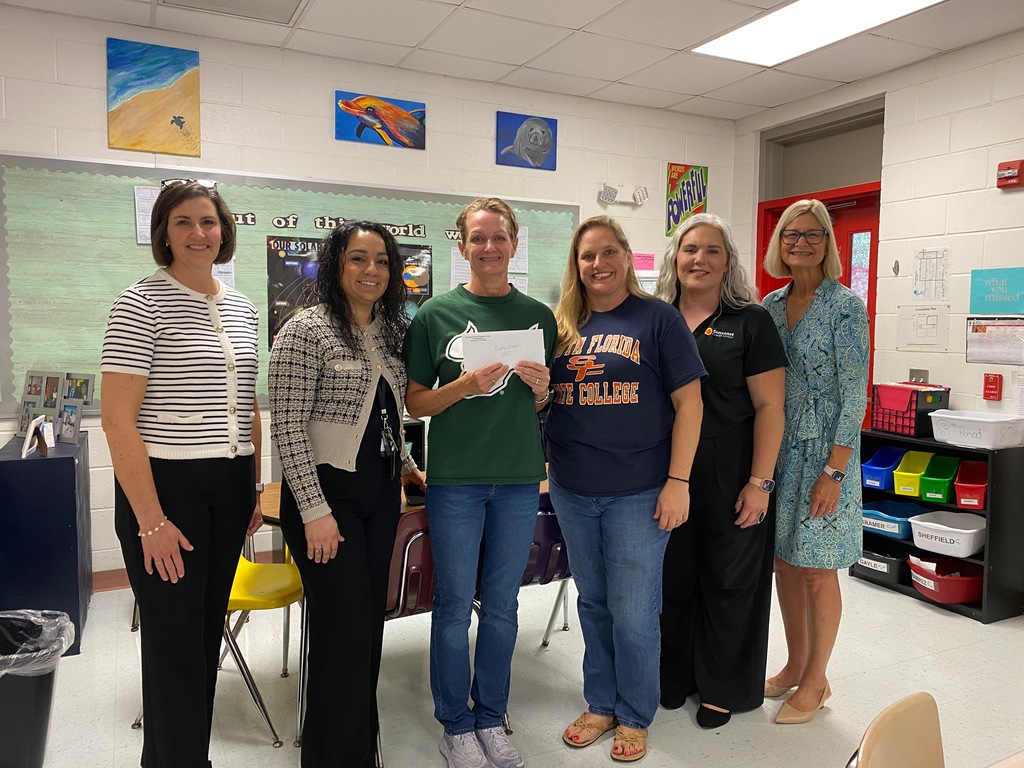 Mrs. Kramer with admin and grant leadership getting her mini- grant.