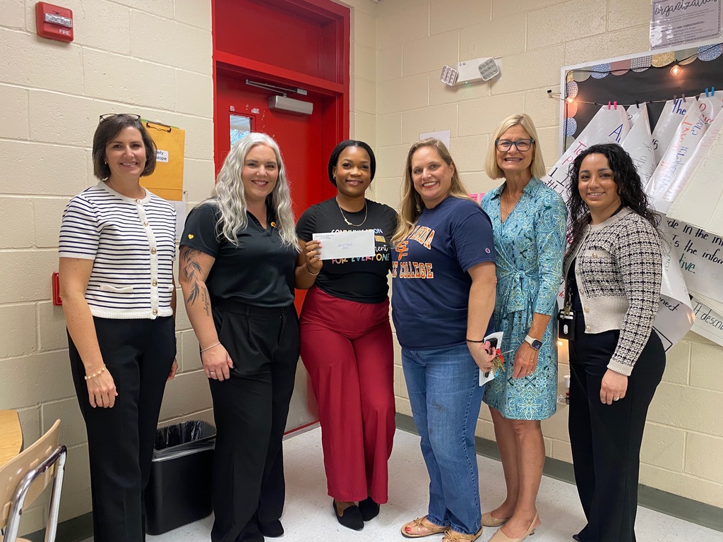 Mrs. Gayle with admin and grant presenters getting her mini- grant.