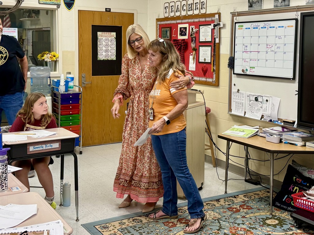 SBHC employee presenting CTE emplyee with mini grant award