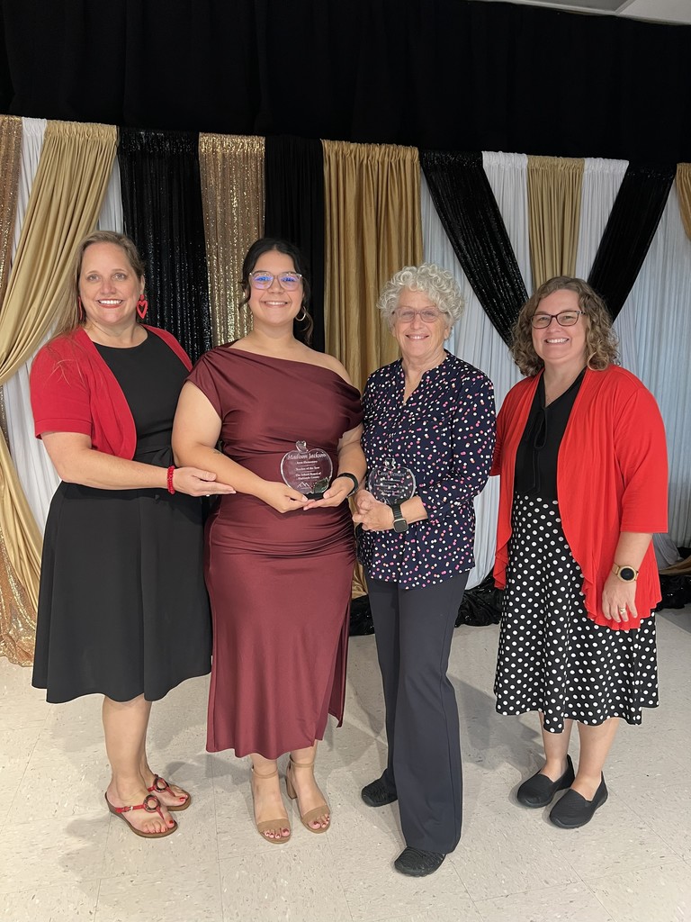 Summit Awards night with Principal Mrs. Cornell, Ms. Jackson, Mrs. Beman and Mrs. Reser. The background is gold, white and black. 