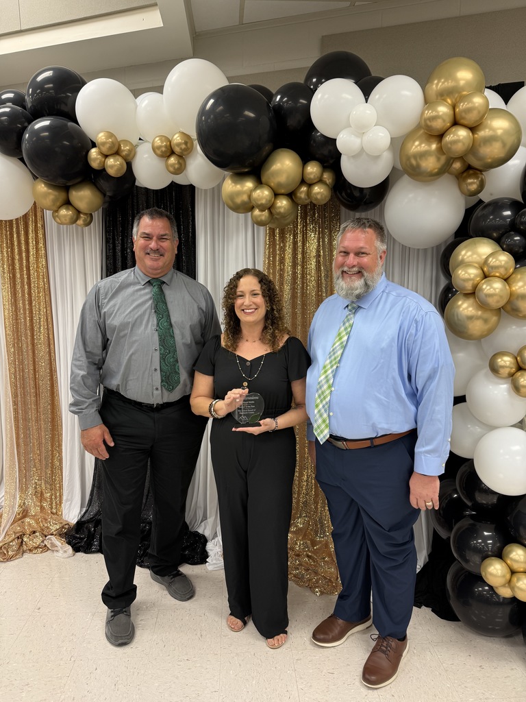 Summit Awards with Mr.  Million, Ms. Hernandorena and Mr. Johnson with Black, gold and white backdrop.