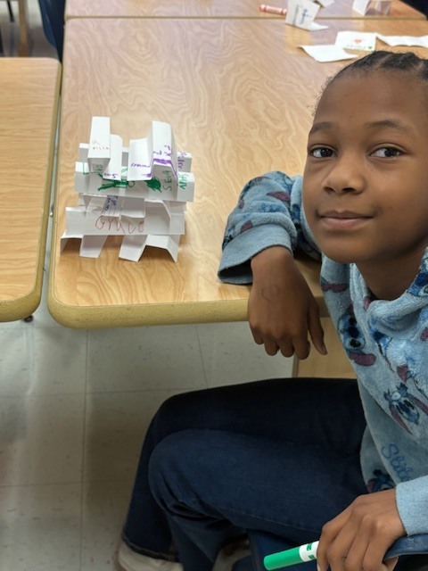 MES Students in STEM lab building Card Towers to deepen understanding of Scientist. 