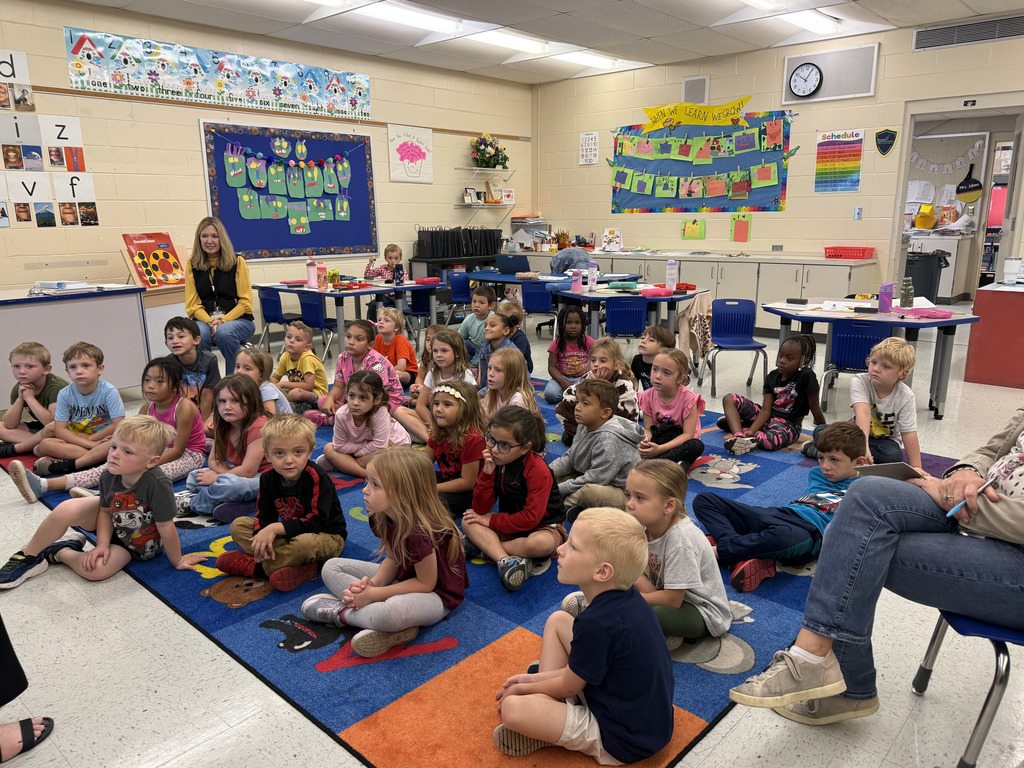 students sitting listening to reader