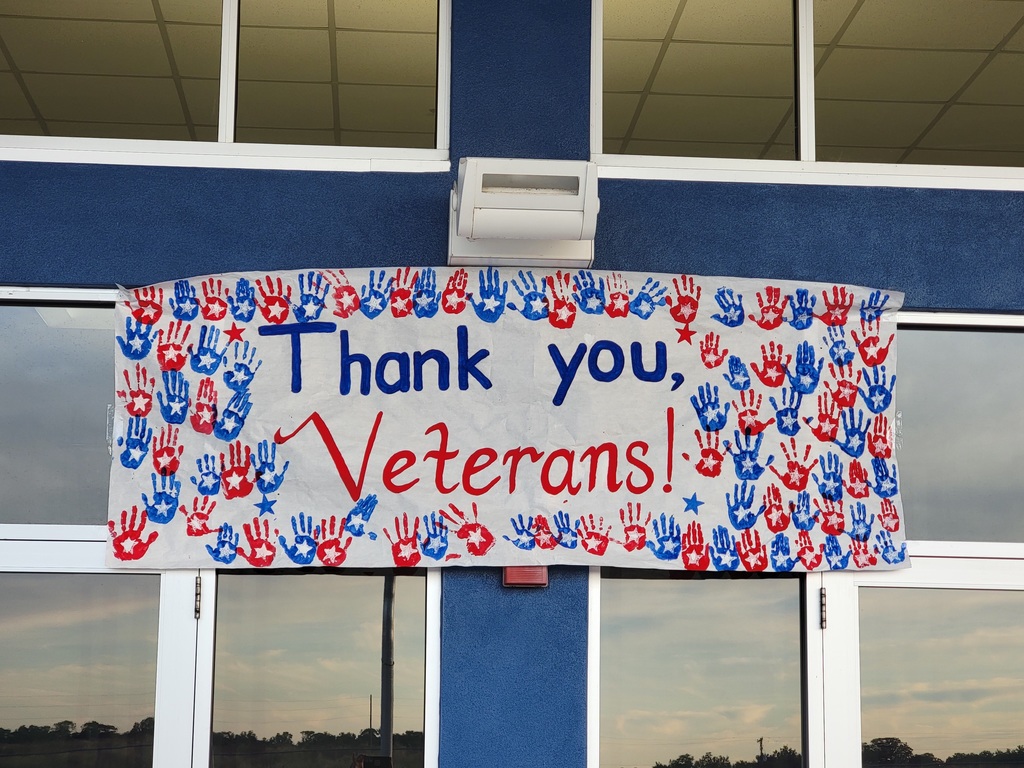 MES Students at our Veteran's Day program. Veterans day sign with kid handprints.
