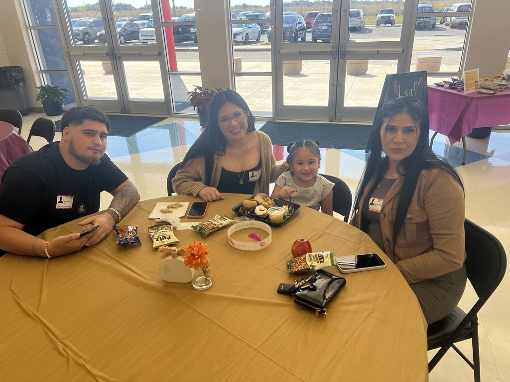 MES families enjoying Thanksgiving lunch with their child.