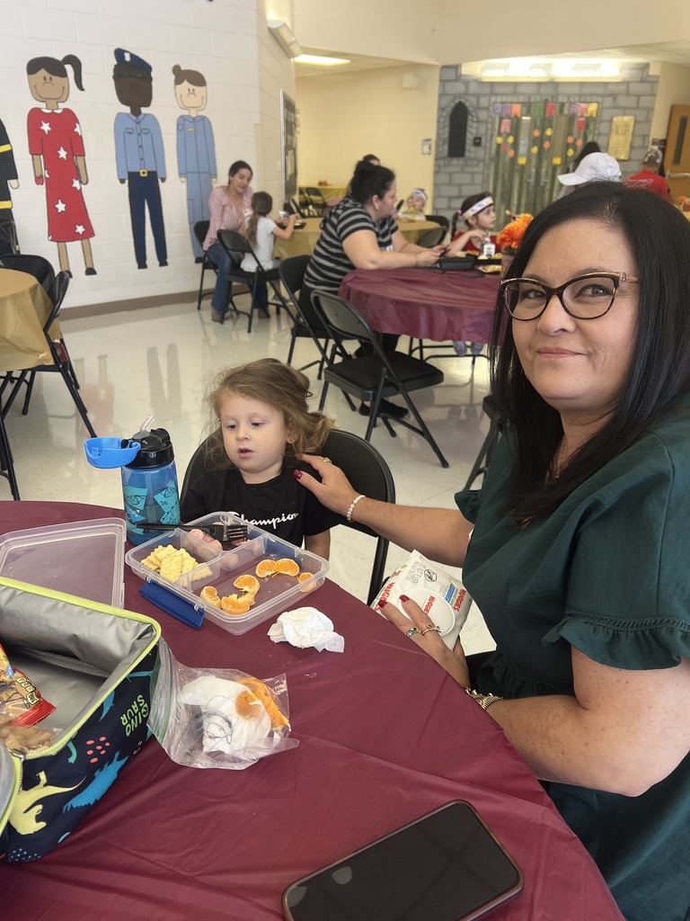 MES families enjoying Thanksgiving lunch with their child.