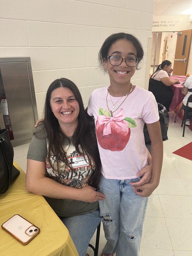 MES families enjoying Thanksgiving lunch with their child.
