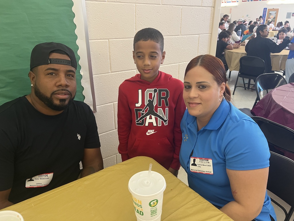 MES families enjoying Thanksgiving lunch with their child.