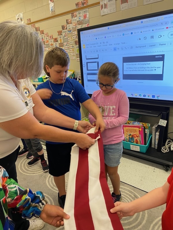 VFW Legionnaires teaching students flag etiquette.