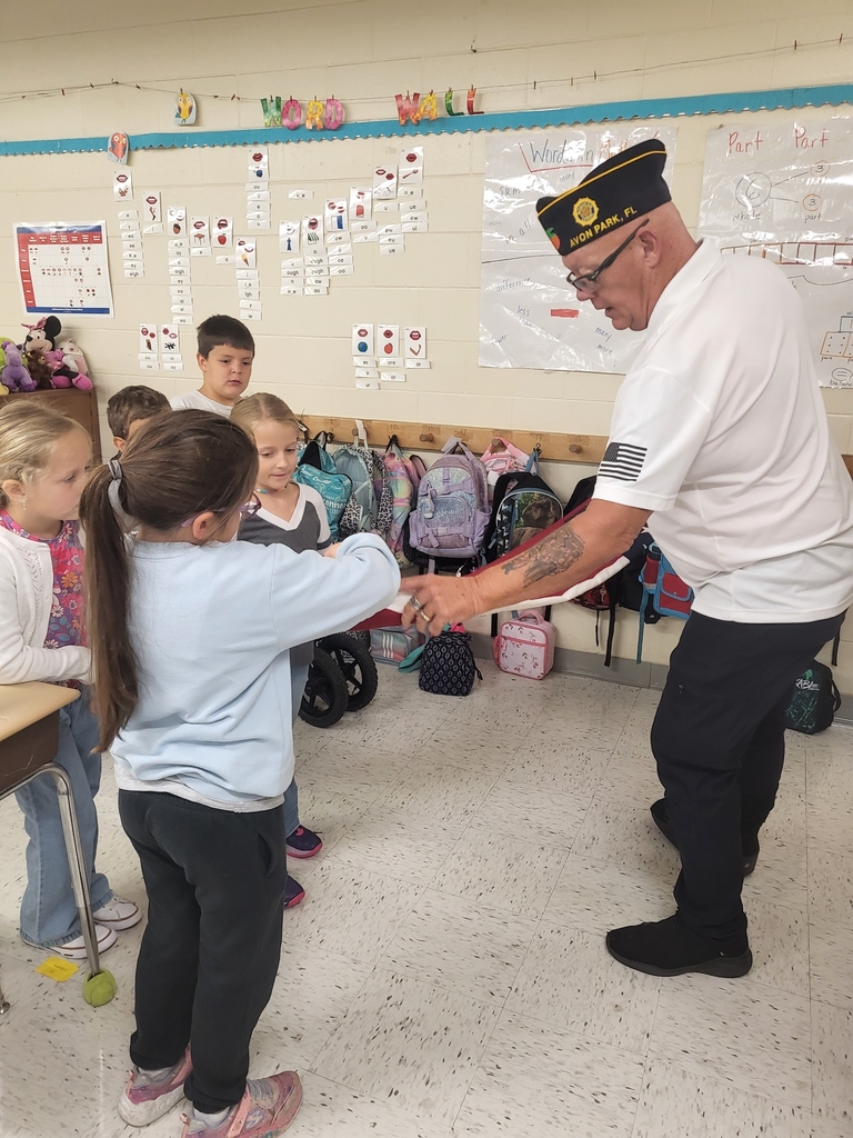 VFW Legionnaires teaching students flag etiquette.