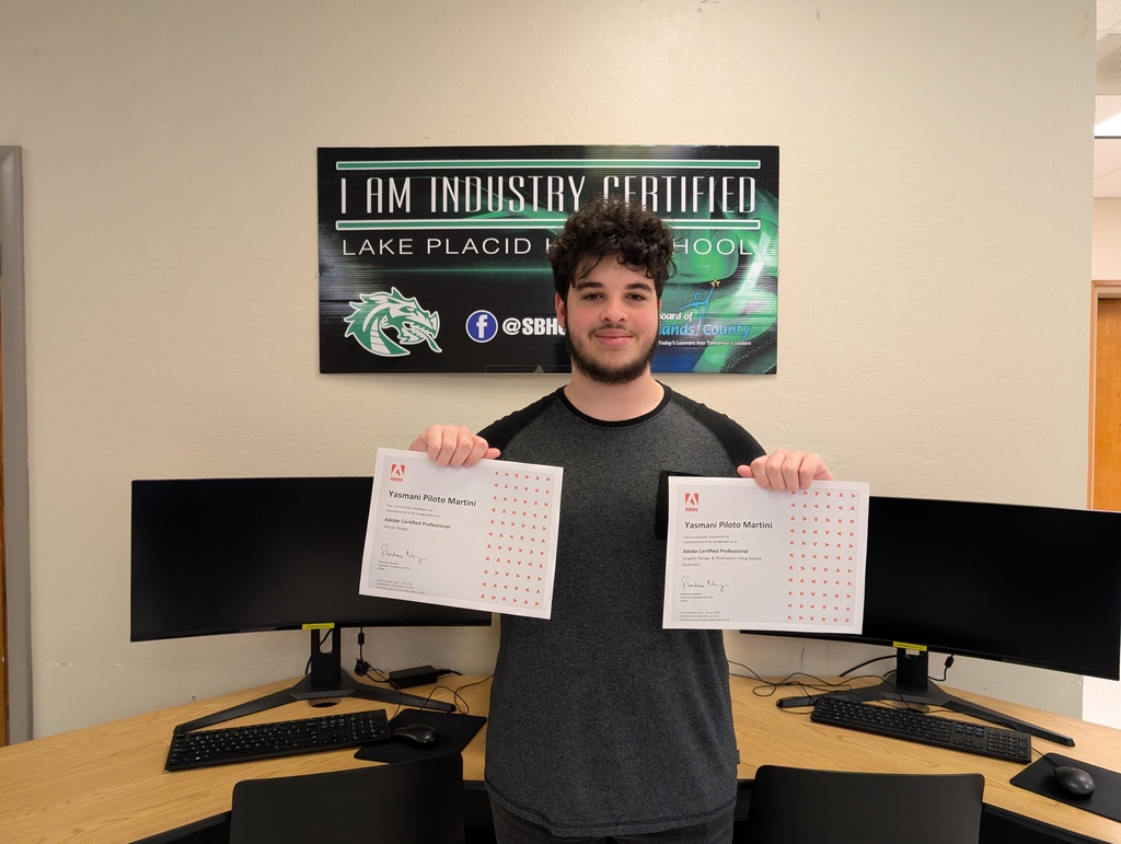 Student holding certificate.
