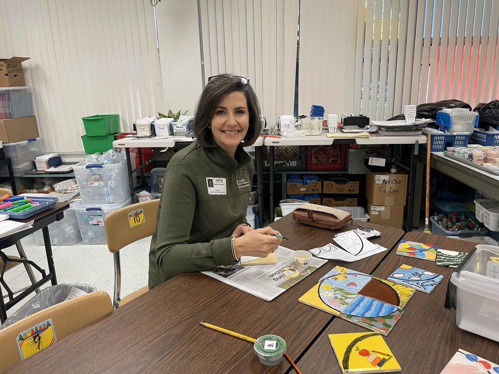 Female painting her tile.