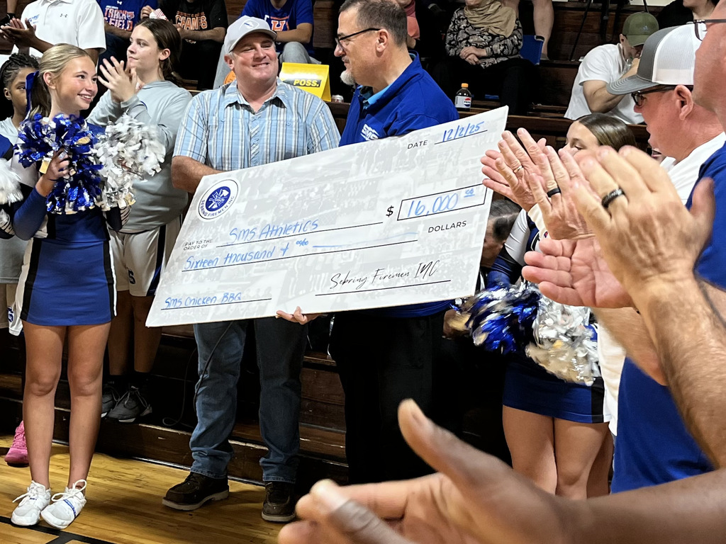Photo of Sebring Firemen members presenting $16,000 to SMS Athletics
