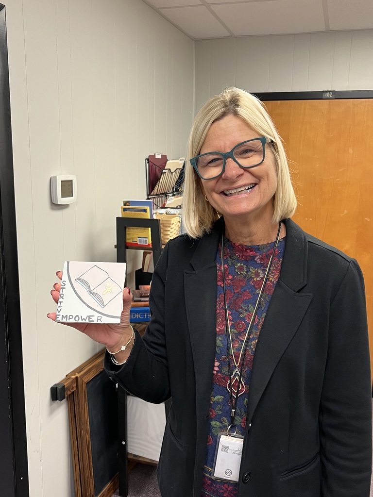 Superintendent holding painted tile