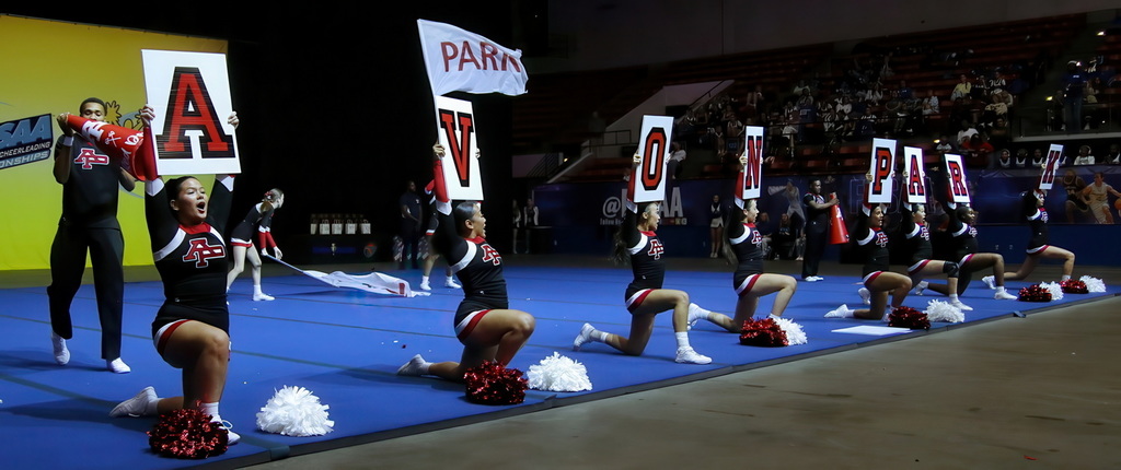 Cheer team is on the mat holding up letters spelling Avon Park.