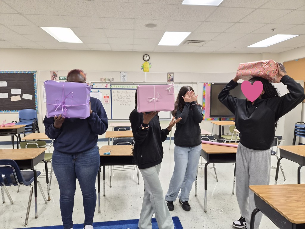 Students holding wrapped presents