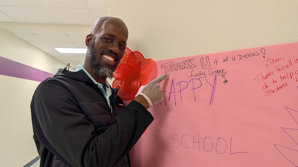 Mr. Brown pointing at Happy Counselor's Week sign