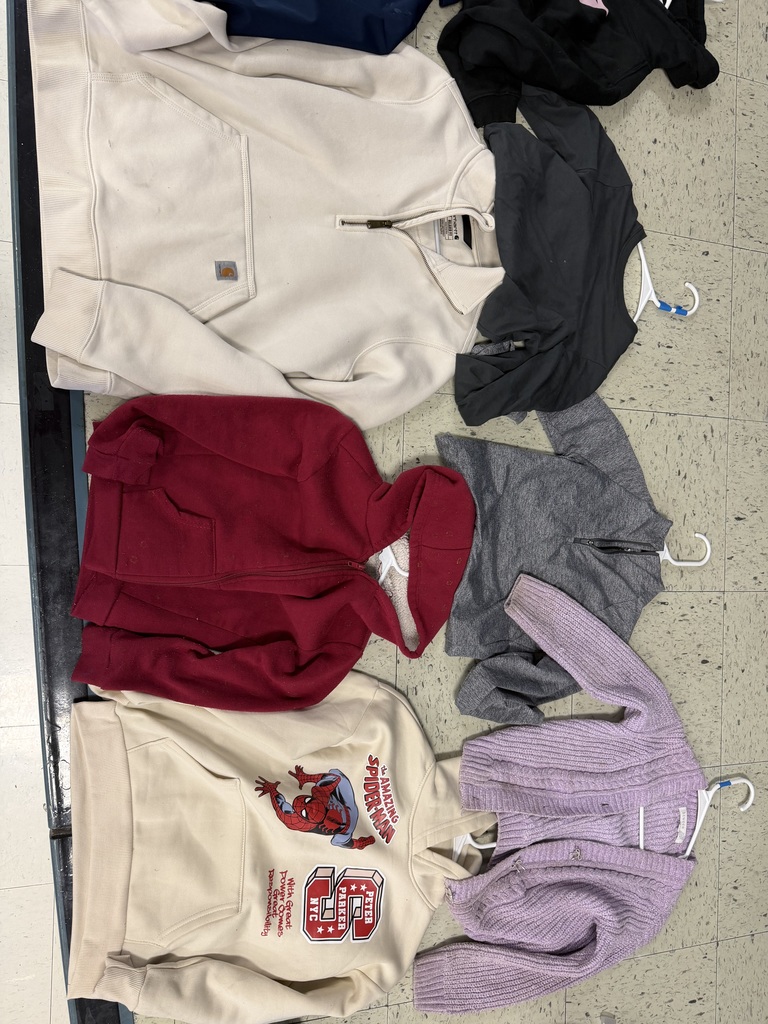 Five sweaters and hoodies. Includes a cream Carhartt quarter-zip, a cream Spiderman hoodie, a dark red fleece-lined hoodie, a grey textured quarter-zip, and a lavender knit cardigan.