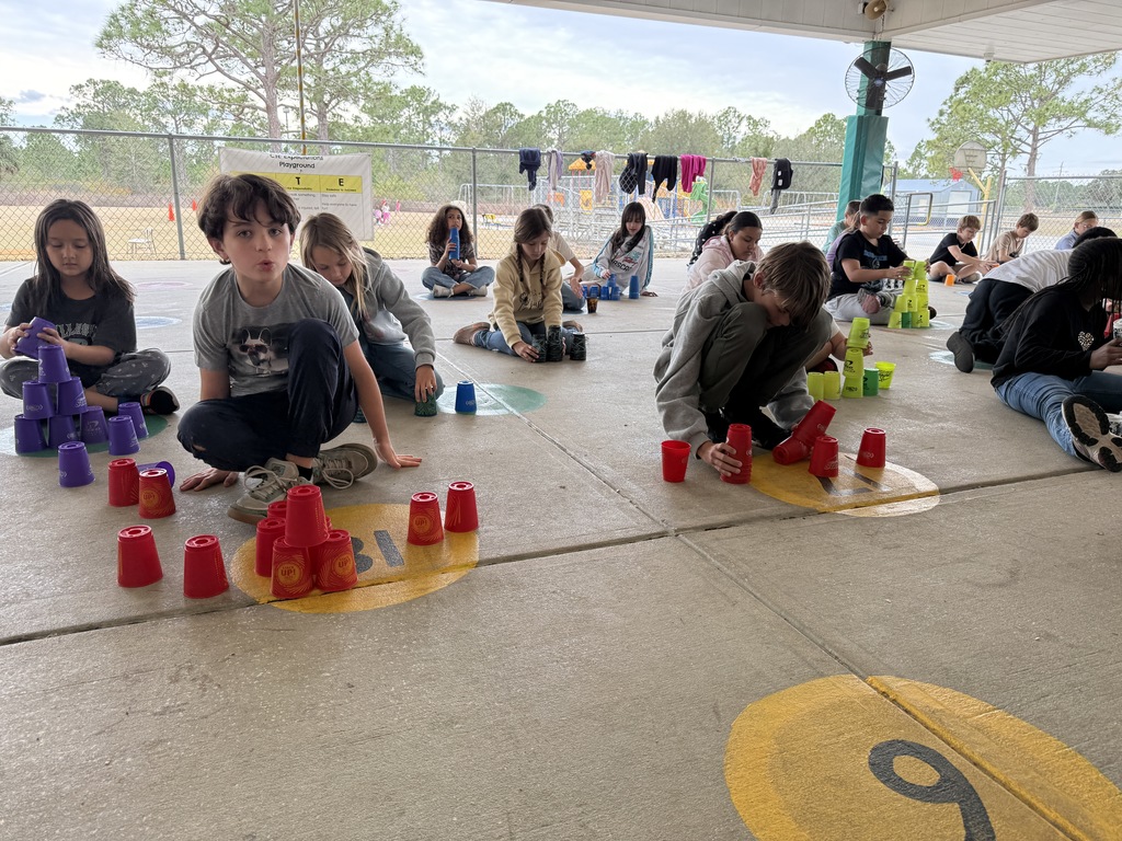 Students stacking cups