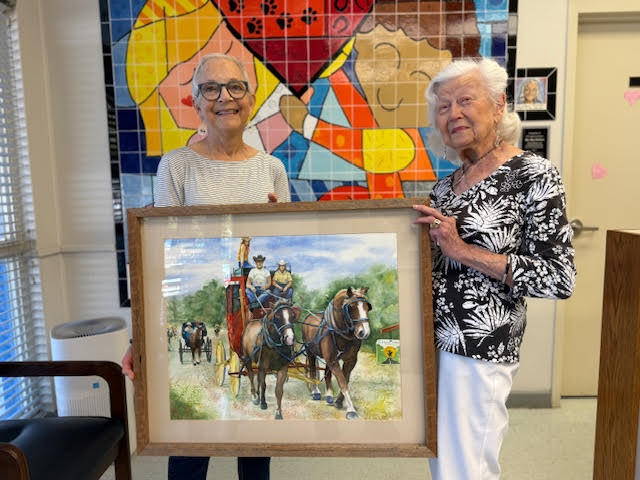 Mrs. Michelle Backus and Mrs. Elsa Kahn generously donating this beautiful painting of the Florida Cracker Trail Riders during one of their historic journey across our state.