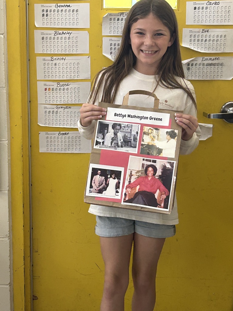 Female student standing with his Black History Month project.