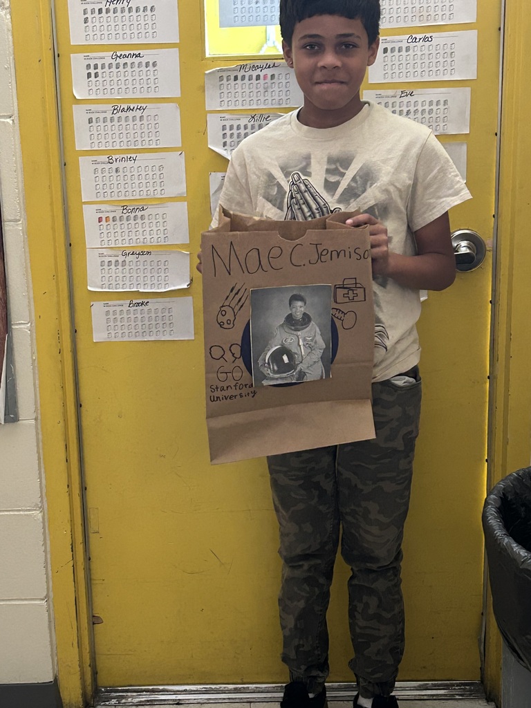 Male student standing with his Black History Month project.