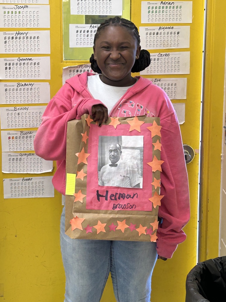 Female student standing with his Black History Month project.