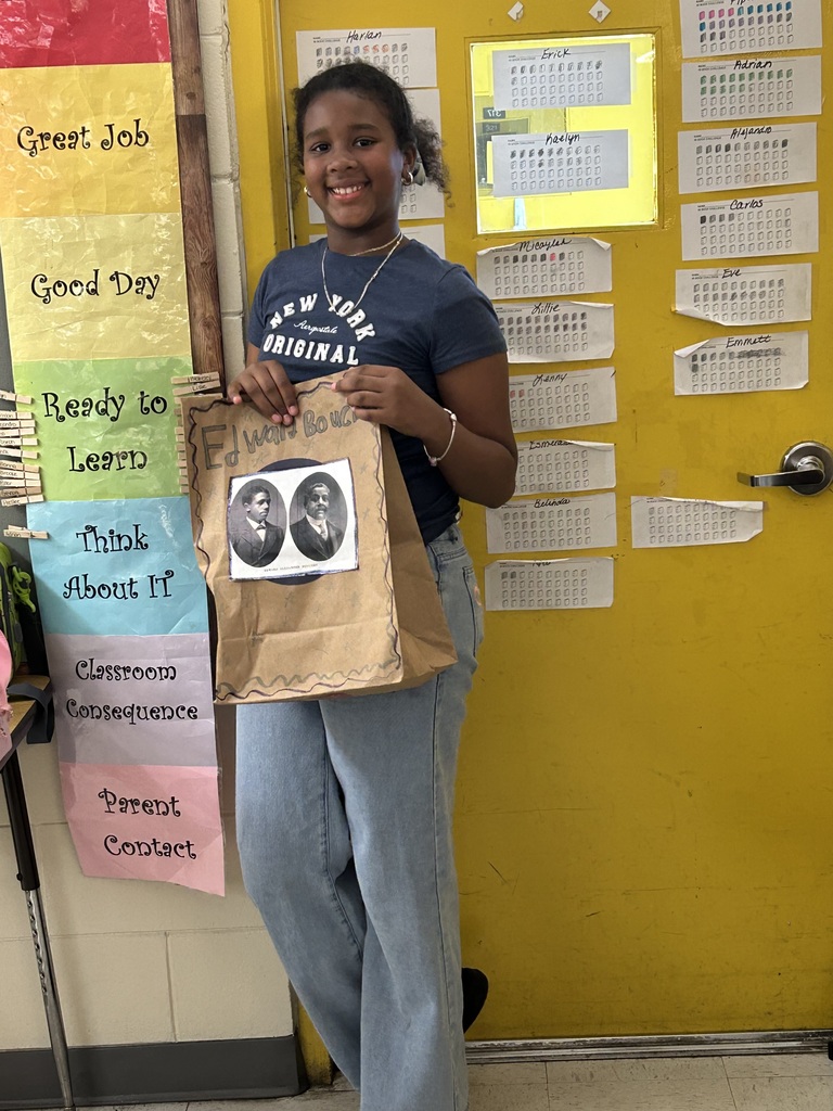 Female student standing with his Black History Month project.