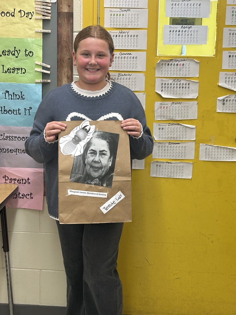 Female student standing with his Black History Month project.