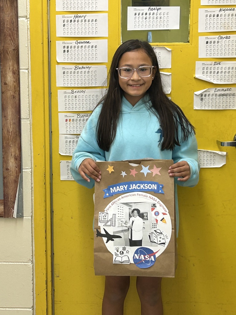 Female student standing with his Black History Month project.