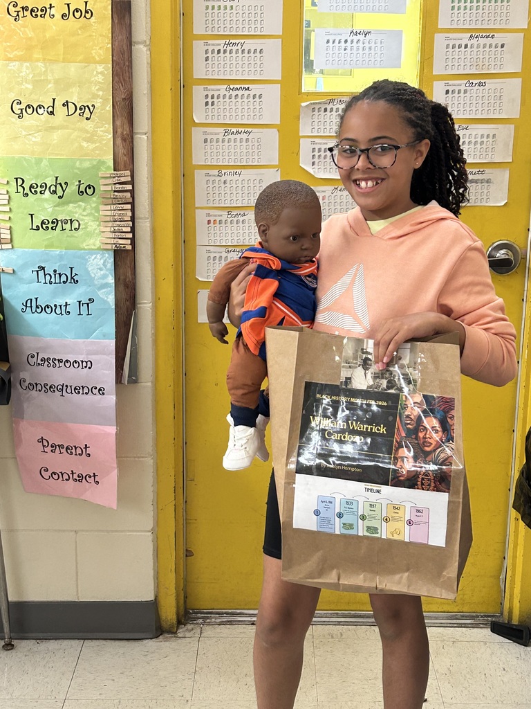 Female student standing with his Black History Month project.