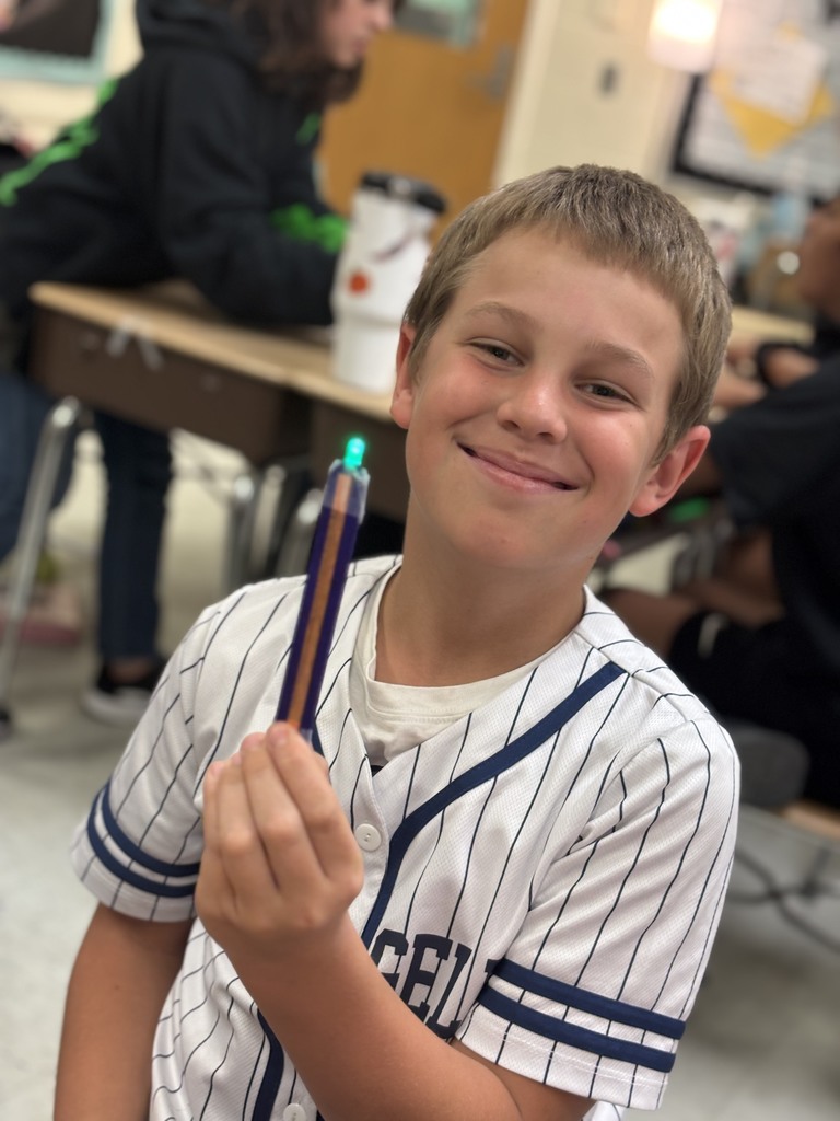 During science block, Mrs. Cook’s 5th graders spent time investigating and illustrating how electricity flows through a closed circuit (a complete loop) by creating their own popsicle stick flashlights!