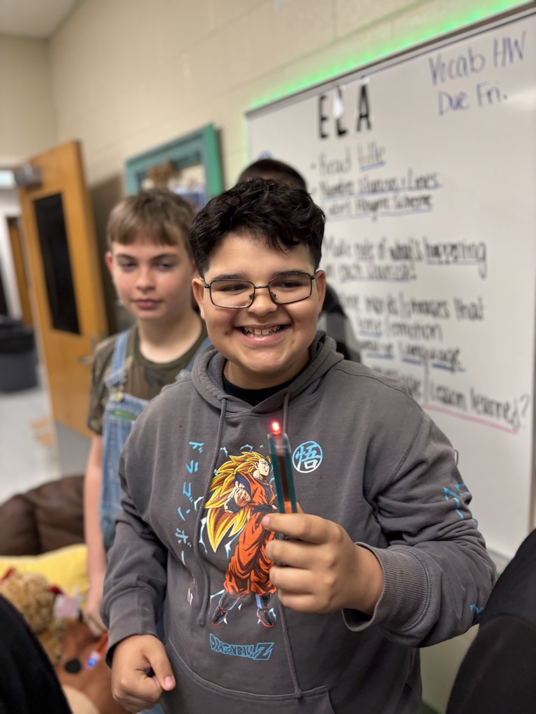 During science block, Mrs. Cook’s 5th graders spent time investigating and illustrating how electricity flows through a closed circuit (a complete loop) by creating their own popsicle stick flashlights!