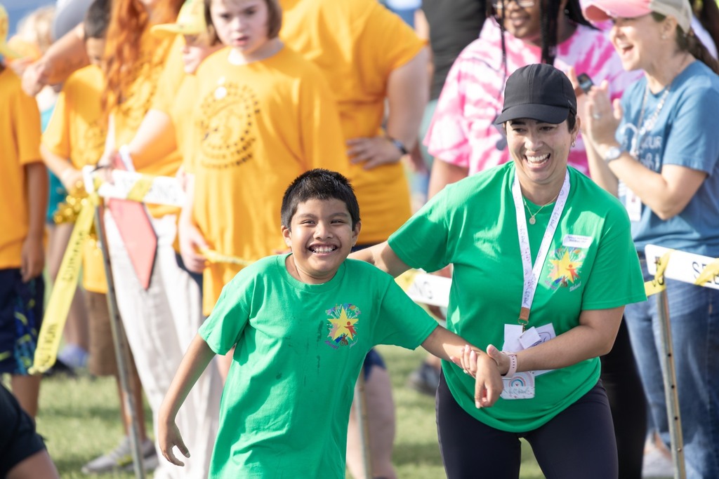 One of our special starts participating with an adult helper in a running race.