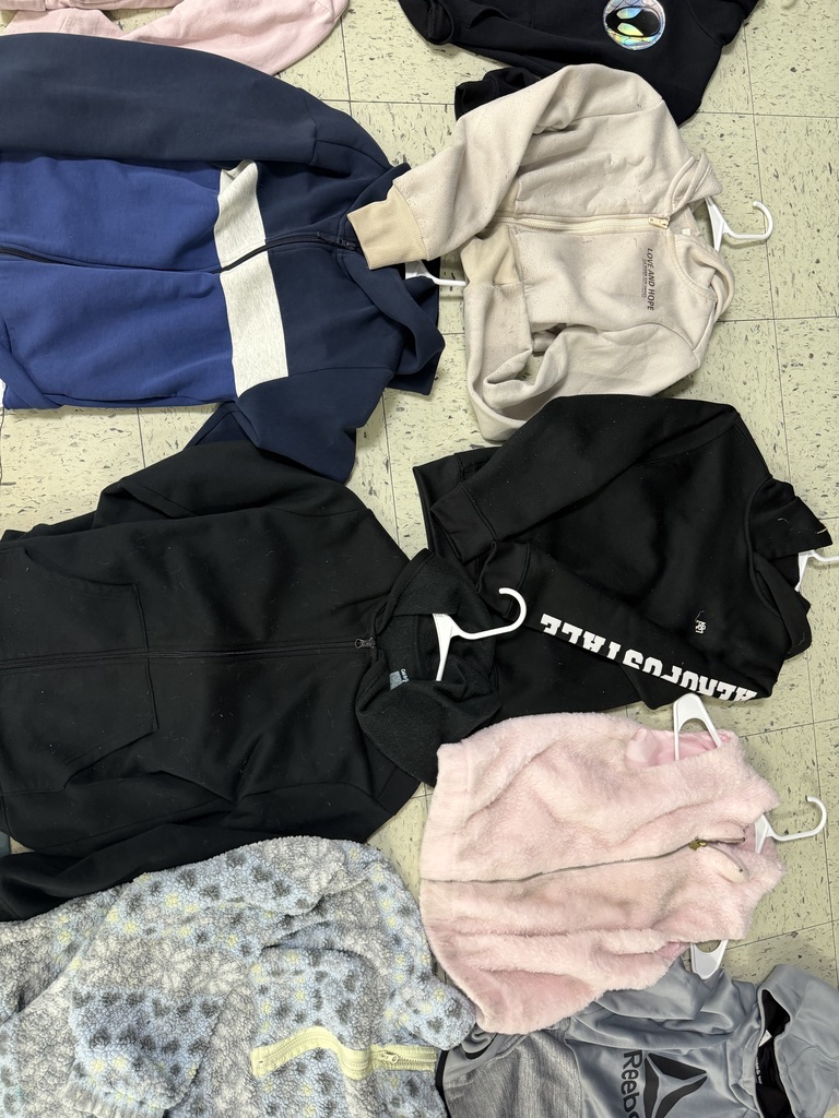 Several jackets and hoodies including a blue and white color-block zip-up, a beige "Love and Hope" hoodie, a black Aeropostale hoodie, a pink fuzzy vest, and a patterned fleece.