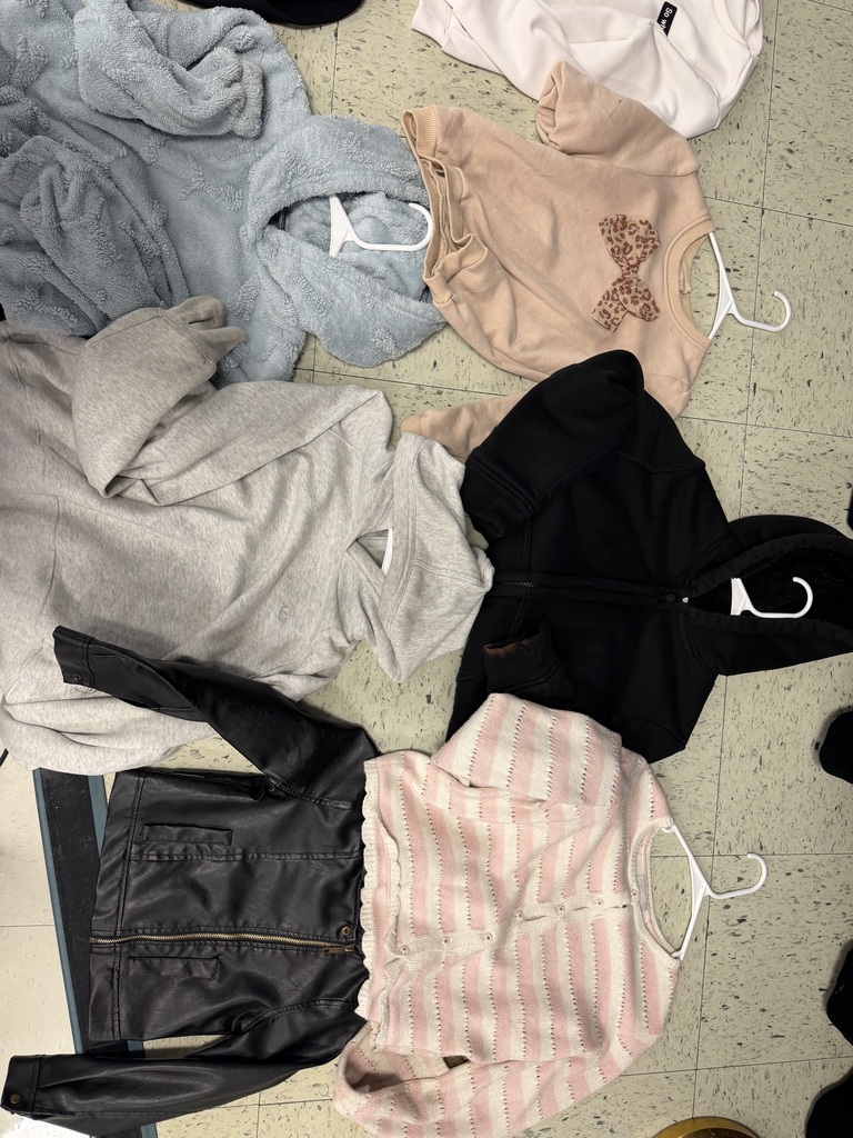 A black leather-style jacket, a pink and white striped cardigan, a grey hoodie, a black zip-up hoodie, and a tan sweatshirt with a leopard-print bow.