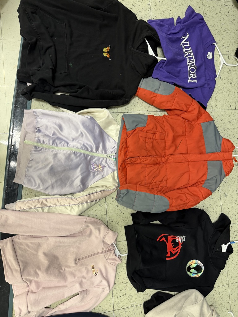 Six assorted children’s tops including a black butterfly hoodie, a purple "Nukimori" shirt, an orange puffer jacket, a lavender satin zip-up, a pink quarter-zip, and a black Spider-Man hoodie.