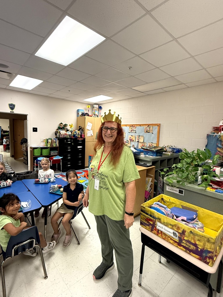 Mrs. Owens who is in her classroom smiling for being our Queen of Staff Attendance.
