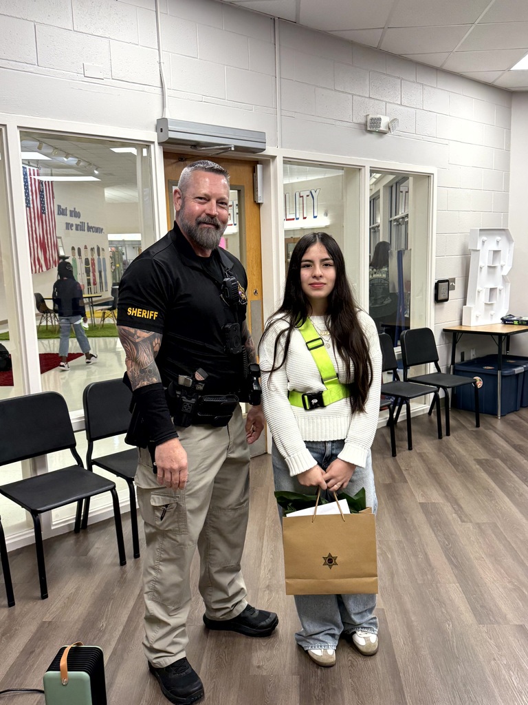 SRD Stewart with DARE Poster winner Emily Botello. Photo taken in front office.