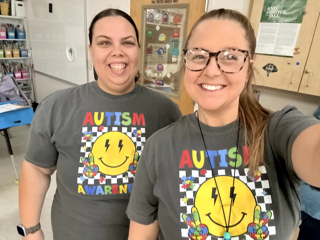 Staff smiling in their Autism Awareness shirts. 