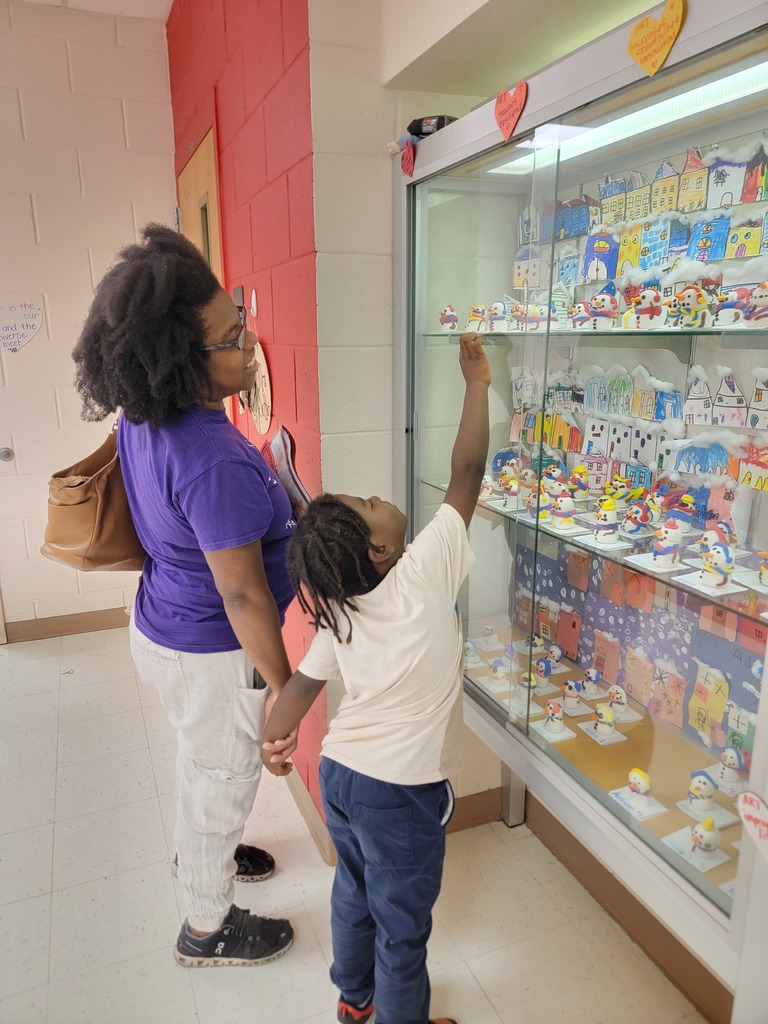 MES students and families look at the Art Work displays.