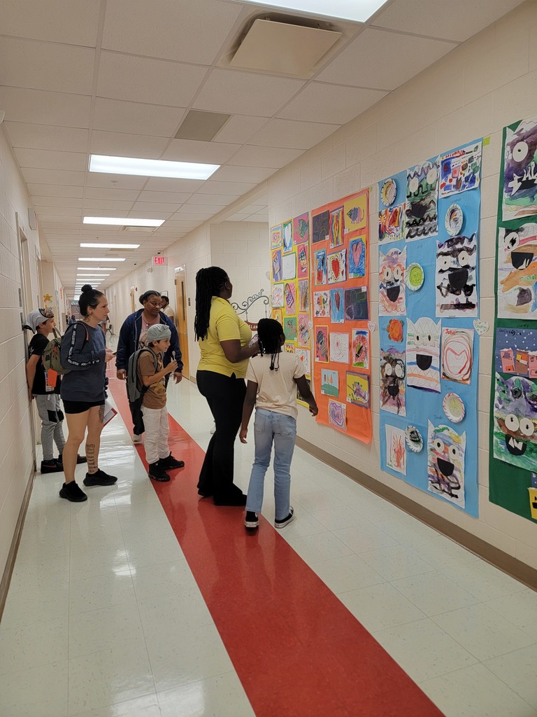 MES students and families look at the Art Work displays.