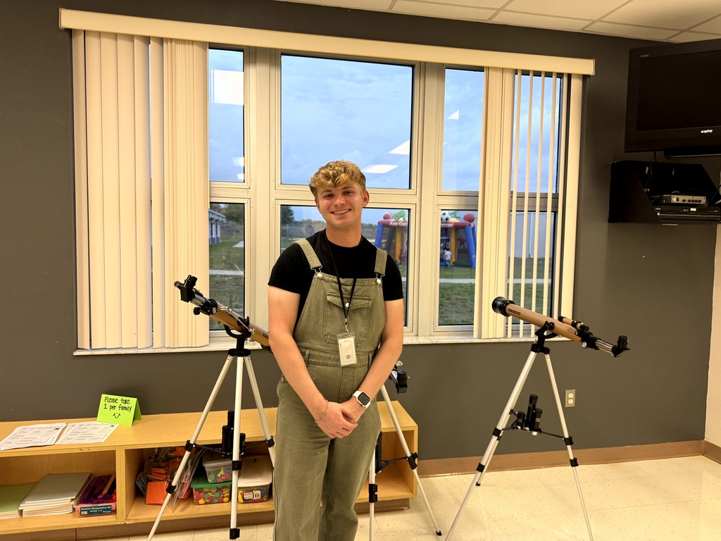 Mr. Cox with the telescopes his family donated to MES.