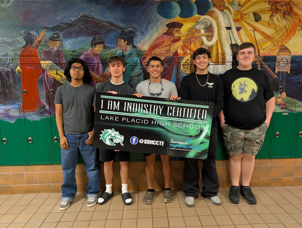 Students holding certificate.