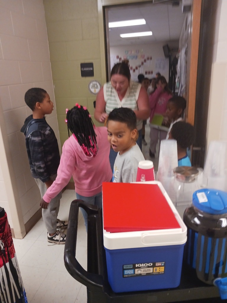 MES Students delivering coffee cart to MES Staff.