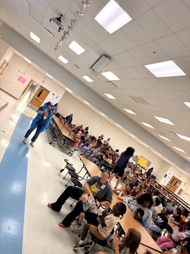 MES Pep rally students at table and cheering on for test success.